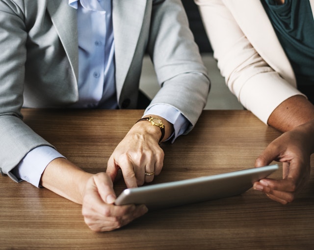 image of two people working with a tablet computer