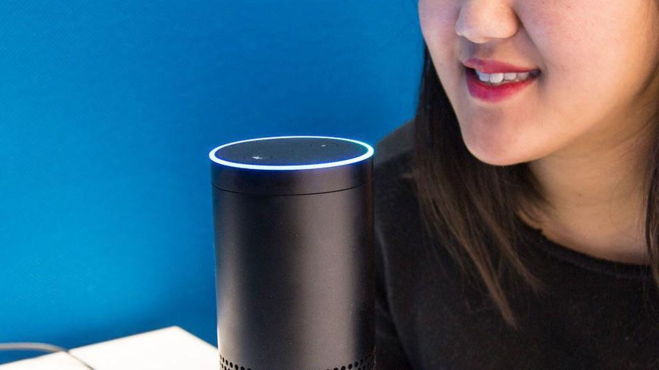 photo of woman speaking to an Alexa Device